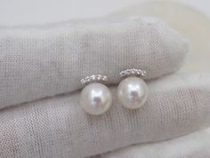 Material : Genuine Natural Freshwater Pearls with 18K Gold / White Gold Posts with Cubic Zirconia Quantity : One Pair Earrings Color : Natural White Pearls with 18K Gold/White Gold Posts Pearl Shape : Round Pearl with High Luster Pearl Size : 7mm approx. Lead Time & Shipping : We will ship your order in 1-2 business days to you once we received it. If we offer FREE DOMESTIC shipping, package will be shipped via USPS First Class mail on orders shipping within the U.S.. **Express Mail orders r White Gold Akoya Pearl Earrings For Wedding, White Gold Pearl Earrings For Wedding With Elegant Design, Luxury Pearl Earrings With Diamond Accents For Wedding, Pearl White Diamond Earrings For Wedding, White Round Bridal Earrings With Prong Setting, White Gold Pearl Earrings With Diamond Accents For Wedding, White Bridal Earrings With Halo Design, Round Bridal Earrings With Prong Setting, Luxury Wedding Pearl Earrings With Diamond Accents