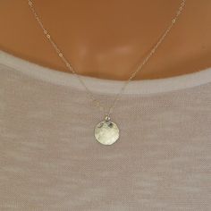 This beautiful simple sterling silver disc charm has been gently hammered to give it a beautiful sheen when the light hits it. It suspends from a sterling silver trace chain.  The disc charm measures 16 mm There is a choice of 14, 16, 18 or 20 inch sterling silver chain. A great everyday wear necklace  The necklace will arrive in a gift box so ready to give to a loved one. Sterling Silver Round Coin Necklace, Sterling Silver Round Disc Coin Pendant, Silver Circle Charm Necklace In Sterling Silver, Sterling Silver Round Disc Coin Necklace For Everyday, Silver Circle Sterling Silver Charm Necklace, Sterling Silver Coin Necklace With Round Disc For Everyday, Sterling Silver Round Disc Delicate Jewelry, Dainty Silver Circle Charm Necklaces, Sterling Silver Delicate Round Disc Jewelry