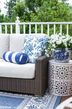 a white couch sitting on top of a blue and white rug