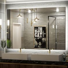 a bathroom with two sinks and a large mirror above it that says the black cat