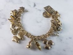 "A WOMENS VINTAGE ESTATE 14k GOLD CHARM BRACELET WITH 17 CHARMS. THE BRACELET WEIGHS 54.8g, AND MEASURES 7 1/2\" LONG. MOST OF THE CHARMS ARE MARKED 14K EXCEPT FOR A FEW OF THEM. THE EIFEL TOWER IS MARKED \"750\". THOSE THAT ARENT MARKED HAVE BEEN TESTED AND ARE GUARANTEED TO BE AS DESCRIBED. ANY QUESTIONS PLEASE DON'T HESITATE TO ASK. THIS MAKES A GREAT GIFT FOR THAT SOMEONE SPECIAL. BE SURE TO CHECK OUT SOME OF MY OTHER GREAT ITEMS UP FOR SALE. THANK YOU." Gold Charm Bracelet Vintage, Charm Bracelet Vintage, Vintage Charm Bracelet, Gold Charm Bracelet, Fine Jewelry Bracelets, Bracelet Vintage, Holy Grail, Bracelets And Charms, New People