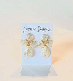 These mother of pearl earrings are handmade. Very elegant while making such a statement. They are great for every day wear, bridal earrings, bridesmaid earrings, and more.  Dimensions: approx. 2" Hypoallergenic gold plated & light weight If you purchase 6 or more, use discount code Bridesmaids15 for 15% off! Handmade Unique Pearl Earrings, Unique White Plug Earrings As Gift, Handmade White Pearl Earrings For Gift, Handmade Mother Of Pearl Drop Earrings, Handmade White Earrings In Mother Of Pearl, Cream Pearl Drop Earrings As Gift, Unique White Pearl Earrings For Pierced Ears, Unique White Dangle Pearl Earrings, Handmade White Mother Of Pearl Earrings