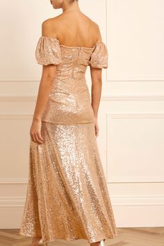 Description & Details NEW SEASON. The Sunbeam Valentina Off-Shoulder Gown in Antique Gold. Turn heads in the dazzling gown. Featuring shimmering 3mm sequins on stretch mesh, an off-shoulder silhouette, and a fluid skirt, this design exudes timeless elegance. Crafted with romantic puff sleeves and soft draping flatter the figure, while an internal corset ensures comfort and support. Perfect for glamorous soirées, this gown promises unforgettable sophistication. - Stretch sequin mesh - Style is fu Gown Gold, Off Shoulder Gown, The Dazzling, Embellished Dress, Flower Dresses, Embroidered Dress, Guest Dresses, New Season, Formal Wear