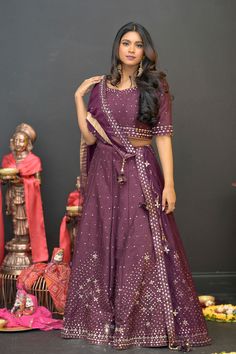 Plum Purple mirror work lehenga choli Matched with Purple mirror work blouse with quarter sleeves. Designed with round neck and has back hooks. Set together with a matching soft net purple duppata with mirror work and have gold border The length of the blouse is 14 inches. Blouse can fit a size 32 to 42 The maximum length of the lehenga will be 41 inches. Slight variation in color is possible due to digital photography. This is a 3 piece set. Care: dry clean only We provide side fitting/sleeves Purple Chanderi Sharara For Reception, Purple Dola Silk Sharara With Gota Work, Purple Gota Work Dola Silk Sharara, Purple Chanderi Lehenga For Reception, Purple Art Silk Sharara With Dori Work, Purple Art Silk Traditional Wear With Gota Work, Purple Chanderi Lehenga With Cutdana, Purple Chanderi Lehenga With Traditional Drape, Traditional Purple Chanderi Lehenga