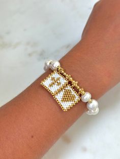 ✨ Shine with our Woven Cross & Heart Bracelet with Pearls and Miyuki Beads: - Crafted with cultured pearls and golden spacers - Features a woven cotton cord, adjustable to fit wrist sizes from 5" to 11" - Heart and cross design intricately made with white and gold glass beads 🎁 Share love and faith with this beautiful bracelet 🌟 F O L L O W * U S * @melimardesigns For info on new products, sales, inspiration and behind the scenes! Handmade Pearl Friendship Bracelet, Bangle Stretch Bracelet With Tiny Beads For Gift, Pearl Bracelet With Letter Beads As Gift, Stretch Bangle Bracelet With Tiny Beads For Gift, Gift Pearl Bracelet With Letter Beads, Beaded Charm Bracelet For Friendship, White Beaded Charm Bracelet Bangle, White Beaded Charm Bangle Bracelet, Gold Beaded Heart Friendship Bracelet