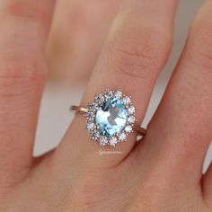 Beautiful Halo Aquamarine Ring ►Made of solid sterling silver with rhodium finish (925) ►Accented with simulated diamonds (CZ) ►Average band width: 1.7 mm Center Stone: Aquamarine Shape: Oval Size: 7.0 x 9.0 mm Carat Weight: 2 ct. (approx.) Gemstone creation: Lab-grown Hardness: 8-8.5 ✓ 100% Nickel-Free ✓ Hypoallergenic ✓ Comfort Fit ✓ Free Ring Box ✓ Free USA Shipping ✓ Ready to ship next business day Aquamarine Halo Ring, Blue Stone Wedding Rings, Oval Aquamarine Ring, Etsy Engagement Rings, Stylish Rings, Aquamarine Ring, Sterling Silver Engagement Rings, Vermeil Jewelry, Aquamarine Rings