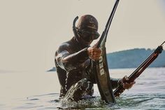 a man holding a fishing pole in the water