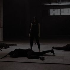 two people are laying on the floor in an empty room with one person holding a knife