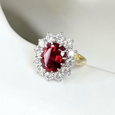 Talk about modern heirloom. This ruby ring is two-tone and antique-inspired. Choose from three options for the gem size. About this ring: Platinum 14k yellow gold shank Small: 8x6 ruby, hand-selected and Chatham lab created, ~1ctw diamonds Medium: 9x7 ruby, hand-selected and Chatham lab created, ~1.1ctw diamonds Large: 10x8 ruby, hand-selected and Chatham lab created, ~1.25ctw diamonds Diamonds: Color G, Clarity VS-SI Photo shown: large version in size 5 Measurements: width: 2.5mm This piece is Ruby Rings Women Vintage, Tuby Ring, Antique Ruby Ring Victorian, Ruby Halo Ring, Diamond Ruby Ring, Ruby Jewelry Ring, Red Diamond Ring, Antique Ruby Ring, Strawberry Ring