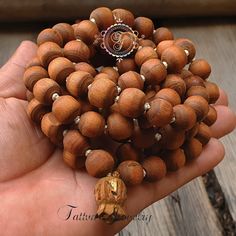 "📿Tulsi Mala handcrafted with Brown Tulsi beads. Suspended in the center is the engraved \"Krishna & Radha\" Guru Bead. When someone wears the tulsi mala, around your neck or around your wrist, you feel protected and focussed. It actually goes a long way in helping you deal with the stress of modern life.📿 🚪 Dimensions ( Approximately ) 🚪 📏Bead size: 11 MM - 12 MM 📏No. of beads: 108 Mala Bead + 1 Guru Bead 📏Mala Necklace Length: 50.0 - 51.0 inches 🚪 Pure Tulsi Beads Sourced from Vrindava Hand Wrapped Mala With Round Beads For Meditation, Hand Wrapped Mala For Meditation, Hand Wrapped Round Beads Mala For Meditation, Meditation Jewelry With Wooden Round Beads, Meditation Jewelry With Round Wooden Beads, Wooden Beads Jewelry For Meditation, Artisan Wooden Beads Bracelet For Meditation, Artisan Hand Wrapped Round Beaded Necklaces, Artisan Hand Wrapped Round Bead Necklaces