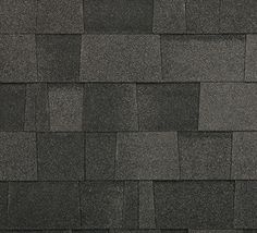 a black and white photo of the roof of a building with gray tiles on it