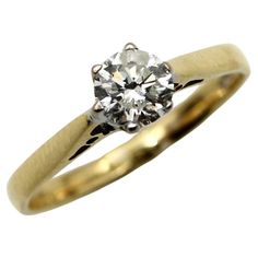 a yellow gold ring with an old cut diamond