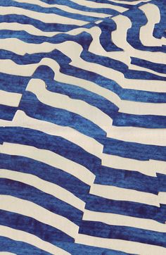 a blue and white rug with wavy lines on it