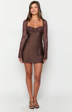 Brown Long Sleeve Mini Dress

How to style:
Make a statement in this stunning mini dress () featuring the sweetest lace details! Our Viola Brown Long Sleeve () Mini Dress is perfect for your next night out or date night (). Elevate the classy silhouette with some gold jewellery and strappy heels for a stunning look!

Features:

  
 * Mini length 
 * Lace overlay on bust 
 * Tie up centre front 
 * Underwire bust cups 
 * Light weight satin body 
 * Invisible zipper on back 
 * Lined body and bust 
 * Unlined sleeves 
 * Bias cut skirt Fitted Mini Dress With Lace Patchwork For Brunch, Fitted Lace Patchwork Mini Dress For Cocktail, Coquette Mini Dress With Lace Trim And Sweetheart Neckline, Lace Trim Mini Dress For Date Night, Coquette Mini Dress With Sweetheart Neckline For Date Night, Fitted Flirty Lace Dress For Date Night, Mini Lace Dress For Date Night, Fitted Chic Mini Dress With Lace Patchwork, Chic Fitted Mini Dress With Lace Patchwork