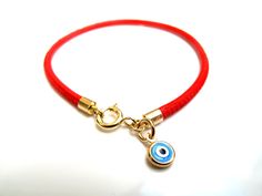 "Kabbalah good luck bracelet 14k gold red string Luxurious bracelet 14k solid Gold beautiful solid yellow 14 k gold and Italian leather bracelet delicate bracelet See description below: * Italian red embroidered leather cord 2.5mm * 14k solid gold and enamel evil eye charm - 6mm - 0.025gr * 14 k solid Gold end caps * 14 solid Gold spring closure *By Symbolina Evil eye: Is a sign of protection that also represents blessings, power, and strength, and is seen as potent in deflecting the evil eye. F Yellow Gold Evil Eye Jewelry For Good Luck, Handmade 14k Gold Jewelry For Good Luck, Yellow Gold Charms Bracelet For Good Luck, Yellow Gold Good Luck Charms Bracelets, Red Spiritual Jewelry For Everyday, Adjustable Yellow Gold Bracelets With Charms, Dainty Evil Eye Jewelry For Good Luck, Adjustable Bracelet With Gold Clasp For Gifts, Gold Evil Eye Jewelry For Blessing