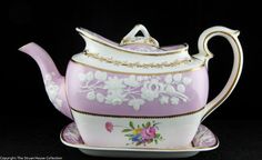 a pink and white tea pot sitting on top of a saucer with gold trim