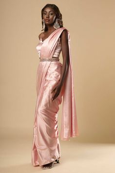 About this Product Saree: Ready to wear , Pre-stitched Saree Type: Ready to wear saree, Pre-stitched Saree Color: Pink Saree Fabric: Satin Belt: Belt sold separately Drape Style: Choose the drape style while order: Standard Open, Pleated or Gujarati Saree length: 5.5 meters Petticoat: Saree comes with an in-built butter crepe petticoat, no additional petticoat is required to wear with the saree. Sizing: Waist is adjustable +/- 1 size with a partial elastic waist band that falls under the drape f Bollywood Silk Draped Dress, Bollywood Style Draped Silk Dress, Fitted Silk Dupatta Draped, Elegant Draped Dress For Diwali, Evening Gown With Pallu In Traditional Drape, Fitted Pre-draped Saree In Tissue Silk, Evening Gown With Traditional Drape And Pallu, Fitted Draped Traditional Wear With Pallu, Silk Pre-draped Floor-length Saree