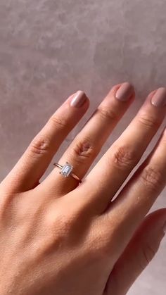 a woman's hand with a diamond ring on it