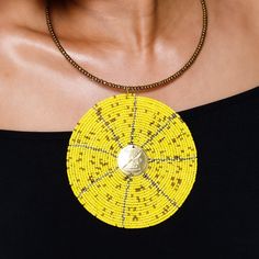 Take your accessory vibes to the next level with this exquisite hand beaded pendant. Superbly crafted and goes well with any outfit. Measures 16 1/2 inches Long. Handmade Yellow Jewelry With Round Beads, Handmade Yellow Beaded Jewelry, Handmade Yellow Round Beaded Jewelry, Artisan Yellow Beads As Gift, Artisan Yellow Beads For Gifts, Yellow Artisan Beads As A Gift, Unique Handmade Yellow Beads, Handmade Yellow Beads, Gold Necklace With Large Pendant And Round Beads