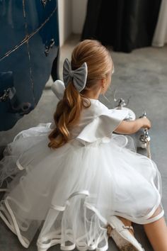 Exclusive white satin flower girl dress with tutu skirt for your little princess.  The girl gown is very elegant, light weight with a pretty cupcake skirt. It has satin to with frills on both sides and tulle skirt with satin ribbon edge.  The dress is lined with 100% cotton for safety and sustainability. Back closure with buttons.  This gown is stunning for flower girls, junior bridesmaids, dedications, portraits, blessing ceremonies, first communion, photo-shoot, a birthday party and much more! Your girl will feel like a princess and get lots of compliments. Very comfortable and easy to wear for long hours. You can find more gorgeous girl dresses in my Sweet Princess Dress shop by following this link: https://www.etsy.com/shop/SweetPrincessDress The dress is made from high-quality fabrics Cupcake Skirt, Gown For Wedding, White Flower Girl Dress, White Tulle Skirt, Flower Girl Gown, Junior Bridesmaids, Satin Flower Girl Dress, White Bridesmaid, Communion Party