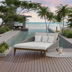 a lounge chair sitting on top of a wooden floor next to a pool and palm trees