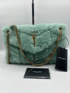 Stunning!!! YSL Yves Saint Laurent Small Shearling Lou Puffer Bag in Iced Mint!!! YSL Yves Saint Laurent Small size Lou Puffer Bag, Shoulder Bag, Crossbody in Iced Mint. Authentic. Super rare color nowadays! Comes with original dust bag, tags, authenticity cards and a gift receipt. Beautiful YSL handbag with gold logo on iced mint shearling with gold hardware. The bag measures 12” L x 7” H x 4” D Strap: 17” Made in Italy! Retail: over $3600 with tax Limited Edition piece! Ysl is not making shear Shearling Bags, Ysl Loulou Bag, Aesthetic Turquoise, Saint Laurent Aesthetic, Ysl Handbag, Ysl Purse, Ysl Handbags, Fluffy Bag, Puffer Bag