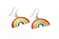 "These sweet rainbow earrings can't wait to spruce up your festival outfit with some serious retro-boho charm! Earring hooks are hypoallergenic. ▲ Rainbow charms measure approx. 1\" x 1 1/8\" ▲ Gold-plated surgical steel earring hooks (hypoallergenic) We try to display product colors as close to life as possible. However, all computer monitors are different and so there might be slight color variations from screen to screen. If you have any questions, feel free to contact us! CARE INSTRUCTIONS J Rainbow Drop Earrings As A Gift, Rainbow Nickel-free Earrings For Gifts, Cute Multicolor Jewelry With Ear Wire, Rainbow Nickel-free Drop Earrings, Nickel-free Rainbow Earrings For Gift, Nickel-free Rainbow Earrings Gift, Cute Multicolor Dangle Jewelry, Nickel-free Rainbow Drop Earrings, Cute Multicolor Jewelry