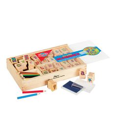 a wooden box with stamps and colored pencils in it next to markers, eraser and stamp pad