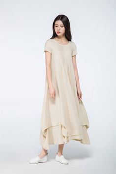 This linen dress is very ease to wear and beautiful. The long linen dress is suitable for any shaped lady. This is a really versatile but unique designer dress.this versatile designer dress can be worn both for daytime or to a party in the evening. Simply pair with the right accessories to dress it up or down depending on the occasion. FEATURES linen blend 50% linen,50% cotton No lining Scoop neckline Short sleeve No zipper A-line Loose fit Asymmetrical hem Perfect for summer,spring,autumn More Beige Flax Summer Dresses, Casual Beige Midi Dress With Asymmetrical Hem, Solid Linen Maxi Dress For Spring, Beige Linen A-line Maxi Dress, Beige A-line Linen Maxi Dress, Summer Wide Hem Maxi Dress, Neutral Short Sleeve Maxi Dress For Summer, Neutral Short Sleeve Summer Maxi Dress, Summer Maxi Dress With Wide Hem