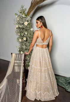 This net lehenga set features all over pearl embroidery and is paired with a tulle dupatta and an embroidered belt.﻿From Seema Gujral's Reverie collection. DELIVERY TIMEPlease allow 4-6 months for your outfit to arrive. FABRIC DETAILSNet. Professional cleaning only. Blue Sequin Lehenga, American Indian Dress, Outfits For Engagement, Indian Outfit Ideas, Peach Lehenga, Sequin Lehenga, Golden Feather, Seema Gujral, Gold Lehenga