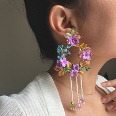 These are handcrafted large floral earrings made with different  textures such as Murano crystal glass, Swarovski  rhinestones, ceramic, beads and soft shades of purple, pink, yellow and LightBlue colour accompanied by touches of polymer clay leaves. 🍃 Made in Silver Plated Wire and Copper wire. MADE IN ENGLAND, UK ️ Each of these delicate flower garden pieces are reproduced in a minimal quantity in order to distinguish their exclusivity.  -All my type of jewellery earring hooks are hypoallergenic, Silver Plated or Gold Plated for use on the earlobe area of the ear. -My designs are handmade by me and designed by me guaranteeing originality. -Sizes are approximate and may vary slightly. -Require careful handling. -Due to the fact that are handmade, respectfully I request not to try to repl Polymer Clay Leaf, Bridesmaids Accessories, Clay Leaf, Earrings Outfit, Polymer Clay Jewelry Tutorials, Floral Chandelier, Bridesmaid Accessories, Beading Ideas, Earrings Polymer Clay