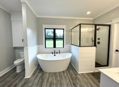 a large white bath tub sitting inside of a bathroom