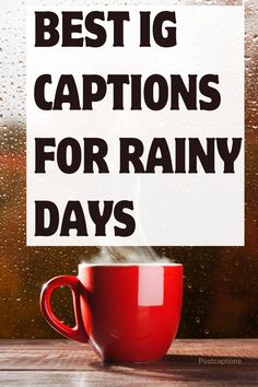 a red coffee cup sitting on top of a wooden table next to a rainy window