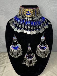 Exquisite Afghan Jewelry Set - Perfect for Special Occasions🇦🇫 Add a touch of exotic elegance to your look with our stunning Afghan jewelry set. Handcrafted by skilled artisans, each piece is a unique work of art that captures the rich cultural heritage of Afghanistan. This set includes a dazzling necklace, matching earrings, and a Tikka headpiece, all intricately designed with traditional Afghan motifs and embellished with vibrant LAPIS LAZULI gemstones. Balochi Doch Jewelry, Blue Latkans Jewelry For Festival, Bohemian Beaded Chandbali Jewelry, Bohemian Chandbali Beaded Jewelry, Adjustable Ceremonial Jewelry With Motifs, Ceremonial Multicolor Metal Jewelry, Temple Style Beaded Jewelry For Festivals, Temple Jewelry Beaded For Festival, Silver Jewelry Sets With Latkans For Ceremonial Occasions