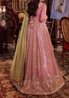 Introducing our New collection 'Chandni Raatein' by Asim Jofa designed to make you look and feel your best. Transformed into a living petal, this pink ensemble is a fairytale garden in bloom. The embroidered Peshwas, a delicate flower unfurling, is adorned with a cascade of light gold dewdrop-like sequins, coupled with 5mm and 9mm gold sequins amidst the intricate amalgam of gold zari and beige threads, weaving a glittering path guiding the gaze gently toward a blooming pink rose. The green embroidered dupatta, a verdant oasis, concludes this dreamlike story with a flourish. Embroidered Front Bodice on Chiffon Embroidered Back Bodice on Chiffon Embroidered Border for Front and Back Neckline, Bodice Hem and Armhole on Chiffon Embroidered Kalis for Peshwas on Chiffon Embroidered Border for H Pink Sets For Reception At Eid Festival, Traditional Pink Georgette Sets, Designer Pink Sharara For Eid, Pink Designer Wear Sets With Sheer Dupatta, Pink Sets For Eid Reception, Pink Semi-stitched Salwar Kameez For Reception, Designer Semi-stitched Pink Sharara, Unstitched Pink Salwar Kameez For Reception, Pink Salwar Kameez With Dabka Work For Wedding