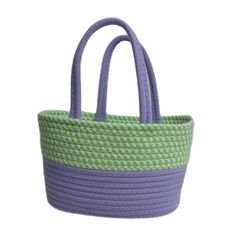 a purple and green basket with handles on it's sides, sitting against a white background