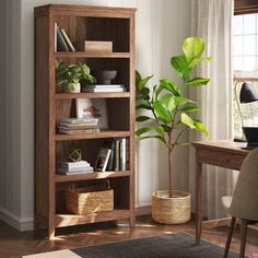 a wooden book shelf with books and plants in it