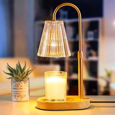 a table lamp sitting on top of a counter next to a candle