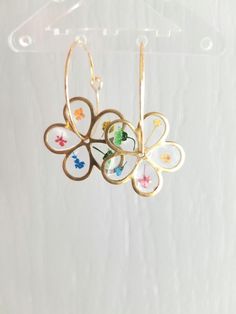 These gold flower fidget hoop earrings are super lightweight and SO FUN to wear! I love the way the daisy spins on the hoop, especially when I'm bored! Made with real pressed flowers and UV resin. They're a cute witchy Birthday gift for your boho style friend! *made with high quality hypoallergenic and nickel free findings. *do not wear in water  Wanna show off your new earrings? We'd love to see you strutting your stuff with your new earrings so be sure to tag us with @prairiesunshowers on Inst Hoop Flower Charm Earrings As Gift, Dainty Hoop Flower Earrings Gift, Handmade Hoop Flower Earrings For Gift, Handmade Delicate Flower Hoop Earrings, Dainty Hoop Earrings With Flower Charm, Adjustable Hoop Flower Earrings As Gift, Adjustable Flower Hoop Earrings As Gift, Gold Whimsical Flower-shaped Earrings, Flower Charm Hoop Earrings Gift