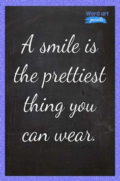 a smile is the prettiest thing you can wear on a blackboard with white writing