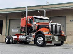 a large semi truck parked in front of a building