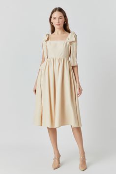 This linen midi dress is sweet as a summer breeze. Its shoulder bow tie adds a playful twist while a square neckline and back smocking detail give it a vintage vibe perfect for sunny days. In a midi length it's modest yet flirty pair it with espadrilles for a casual brunch or dress it up with wedges for an evening stroll. Whether you're sipping sangria in Barcelona or touring Tuscany's countryside this dress will keep you looking chic and feeling cool as temperatures rise. Best of all linen fabr Spring A-line Midi Dress With Tie Straps, Spring A-line Midi Dress With Bow, Square Neck Midi Dress For Day Out, Elegant Square Neck Picnic Dress, Spring Midi Dress With Tie Straps For Garden Party, Knee-length Midi Dress With Tie Back For Garden Party, Summer Brunch Linen Midi Dress, Midi Dress With Smocked Back For Day Out, Knee-length Tie Back Midi Dress For Garden Party