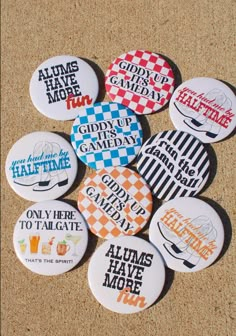 six badges with different sayings on them sitting on the ground in front of a cork board