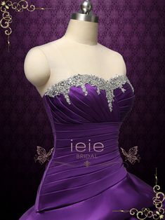 a purple dress with white lace on the top and silver beading around the bust