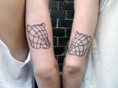 two people with matching tattoos on their arms