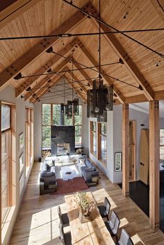 an open living room and dining area in a house with wooden beams on the ceiling