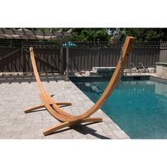 a wooden chair sitting next to a swimming pool