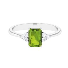 Product Details The gleaming shank features an emerald cut peridot in the center that mesmerizes with its olive-green color. Glimmering trio of round Diamond flank the center gemstone. The peridot is held firmly in a prong setting, which beautifies this solitaire engagement ring even more. Present this exquisite token of love to your beloved and mark your union forever. Product Information SKU SHP-RINGS0821229263 Width 3.5 mm Height 7.5 mm Weight 1.75 gm (Approximate) PERIDOT INFORMATION No.of Stones 1 Pieces Total Weight 1.80 Carat (Approximate) Dimension(approx) Emerald Cut-6X8 mm-1 Pcs Color Green Cut Brilliant Shape Emerald Cut Setting Type Prong-Setting Quality Grade AAA DIAMOND INFORMATION No.of Stones 6 Pieces Total Weight 0.18 Carat (Approximate) Dimension(approx) Round-1.70X1.70 m Peridot Engagement Ring, Peridot Engagement Rings, Ring With Diamond, 18k Yellow Gold Ring, Olive Green Color, Diamond Solitaire Engagement Ring, Diamond Cluster, Solitaire Engagement, Solitaire Engagement Ring