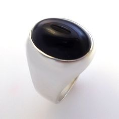 Masculine elegance. A truly stunning ring. Our own unique spin on a smart looking, timeless classic. We use finest quality, natural Black Onyx in a specially cut high dome that shows more stone which creates a unique and striking effect. This ring is solid- not hollowed out underneath which gives it a substantial value and weight and nicer feel and weighs from approx. 24 to 30 grams depending on the ring size. Truly looks great on a a wide range of finger sizes. (pictured on a size 10 ring finge Mens Black Onyx Ring, Modern Oval Cabochon Moonstone Ring, Modern Oval Cabochon Signet Ring For Formal Occasions, Elegant Black Dome Ring With Polished Finish, Formal Onyx Open Ring, Modern Sapphire Ring Oval Cabochon For Formal Occasions, Classic Domed Sapphire Ring With Polished Finish, Modern Dome Ring With Cabochon, Elegant Domed Moonstone Ring