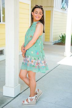 The Shelly Dress is perfect for a beach vacation or dinner by the ocean! This mini dress features a relaxed fit, sleeveless design, mock neckline with a self tie at the back, and a playful back cutout. The dress showcases a green hue with a beachy print of shells, starfish, and coral. Pair with our sunglasses and some sandals for a chic look! It is lightweight, fully lined, and fits true to size. 100% Polyester Brand- Olivaceous Model is 5'5" and is wearing a small Casual Green Dress For Beach Cover-up, Breezy Mini Dress For Beach Party In Spring, Breezy Mini Dress For Spring Beach Party, Green Mini Dress For Summer, Flowy Green Summer Dress, Summer Breezy Halter Neck Mini Dress, Breezy Halter Neck Mini Dress For Summer, Casual Green Sleeveless Dress For Day Out, Casual Green Dress For Vacation